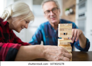 Happy Senior Marriage Playing Jenga Together