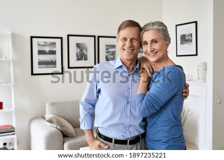 Similar – Image, Stock Photo A couple of adult lovers, sitting on a couch covered with a leopard pattern blanket, watch a romantic movie on television