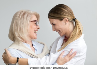 Happy Senior Mother Embracing Adult Daughter Laughing Together, Smiling Excited Aged Older Lady Hugging Young Woman, Sincere Family Of Different Age Generations Bonding Talking Joking Having Fun