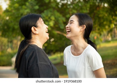 Happy Senior Mother Talking And Laughing With Asian Young Adult Daughter In The Park, Healthy Body And Mind Lifestyle, Family Togetherness, Mother And Daughter, Mother Day Concept