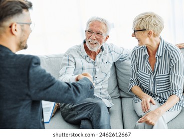 Happy senior old family couple clients make financial insurance estate business deal handshake agent lawyer, satisfied mature customers shake hand meeting bank manager agree on investment contract - Powered by Shutterstock