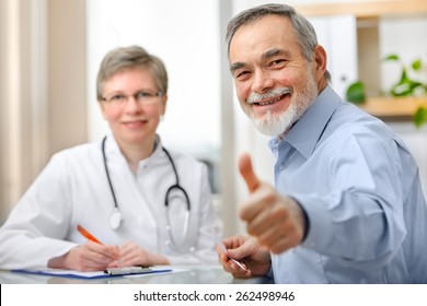 Happy Senior Patient And Doctor At The Doctor's Office