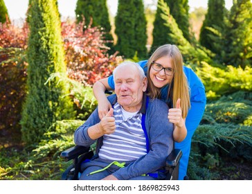 Happy senior patient with doctor portrait at the nursing home garden.