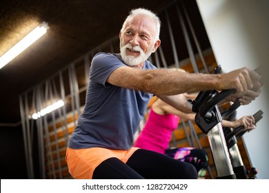 Happy Senior People Doing Exercises In Gym To Stay Fit