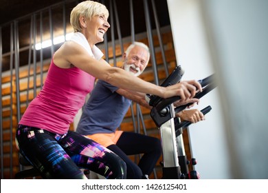 Happy Senior People Doing Exercises In Gym To Stay Fit