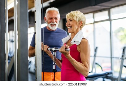 Happy senior people doing exercises in gym to stay fit. People sport concept. - Powered by Shutterstock