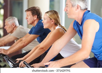 Happy Senior People Group Exercising In Spinning Class In Gym