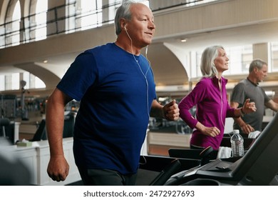 Happy, senior people and running on treadmill for wellness, exercise, and fitness in retirement. Men, woman and friends training in gym for cardio workout, physical vitality and body strength - Powered by Shutterstock