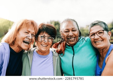 Happy senior people women after sport exercise workout having fun outdoors at park city - Focus on old female wearing eyeglasses