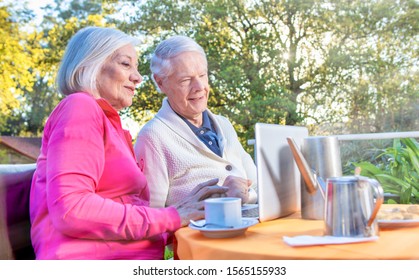 Happy Senior Retired Couple Relaxing Outdoor In The Garden, Making Breakfast. Retirement Concept.