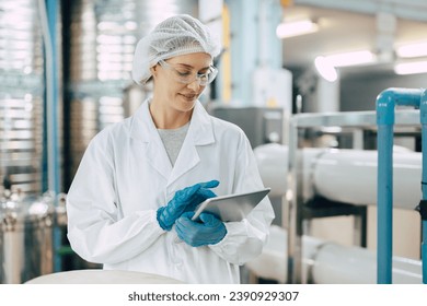 Happy senior science staff women worker work control quality of water in drinking water plant using tablet to record jobs. - Powered by Shutterstock