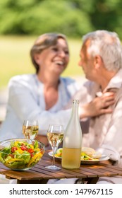 Happy Senior Wife And Husband Dining Outdoors