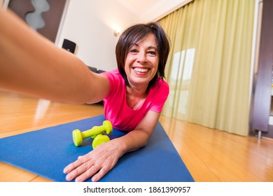 Happy Senior Woman Doing Fitness Workout At Home - Older Female Taking A Selfie - Bright Filter