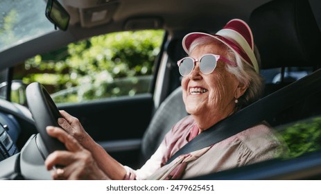 Happy senior woman driving car alone, enjoying car ride. Safe driving for elderly adults, older driver safety. - Powered by Shutterstock