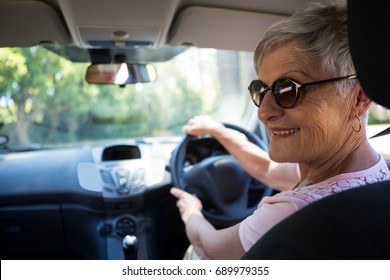 Happy Senior Woman Driving A Car