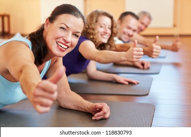 Happy senior woman in fitness class in a health club holding her thumbs up - Powered by Shutterstock