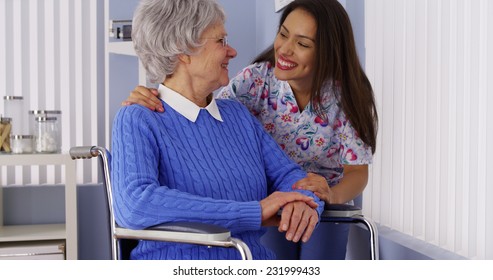 Happy Senior Woman With Friendly Mexican Caregiver