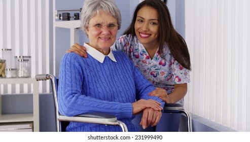 Happy Senior Woman With Friendly Mexican Caregiver