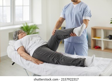 Happy senior woman lying on exam couch while chiropractor, osteopath or physiotherapy specialist is examining her leg and knee. Osteoporosis treatment, physical therapy, remedial exercise concept - Shutterstock ID 2157922317