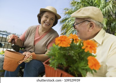 Happy senior woman and man working in the garden - Powered by Shutterstock