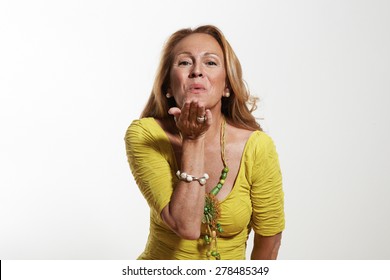 happy senior woman sending a kiss