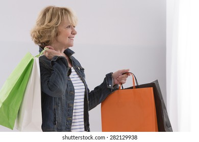 Happy Senior Woman With Shopping Bags