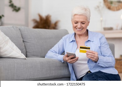 Happy Senior Woman Shopping Online With Smartphone And Credit Card At Home Or Paying Utility Bills In Application