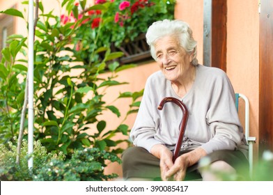 Happy Senior Woman Sitting Outside