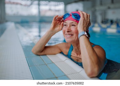 Happy senior woman in swimming pool, leaning on edge. - Powered by Shutterstock