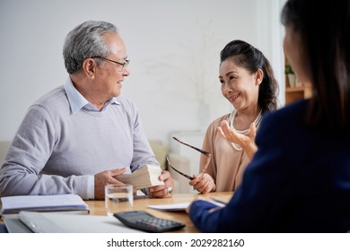 Happy Senior Woman Taking Off Glasses And Almost Crying After Making Down Payment For New House