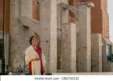 Happy Senior Woman Walking Around A Mexican Catholic Church Square. Plaza Fundadores, Durango, México.