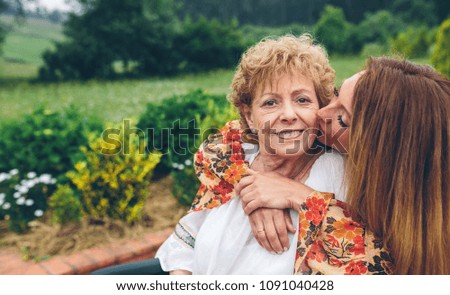 Similar – Woman taking selfie with older mother in wheelchair