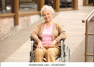 Happy Senior Woman In Wheelchair Near Ramp Outdoors