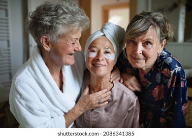 Happy Senior Women Friends In Bathrobes Looking At Camera Indoors At Home, Selfcare Concept.