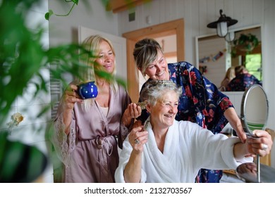 Happy Senior Women Friends In Bathrobes Having Fun Indoors In Bathroom, Selfcare Concept.