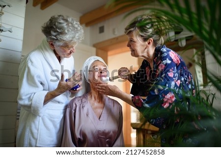 Similar – Image, Stock Photo Caregiver helping elderly female patient to get out of bed