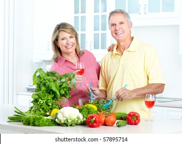 Happy Seniors Couple Cooking At Kitchen