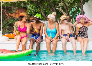 Happy seniors having party in the swimming pool - Elderly friends at a pool party during summertime - Powered by Shutterstock