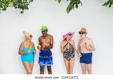 Happy Seniors Having Party In The Swimming Pool - Elderly Friends At A Pool Party During Summertime