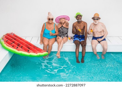 Happy seniors having party in the swimming pool - Elderly friends at a pool party during summertime - Powered by Shutterstock