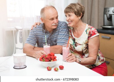 Happy seniors holding glasses with healthy homemade fruit drink fresh smoothie in kitchen
 - Powered by Shutterstock