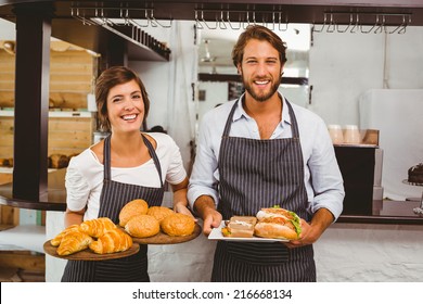 Happy Servers Holding Plates Of Food At The Coffee Shop