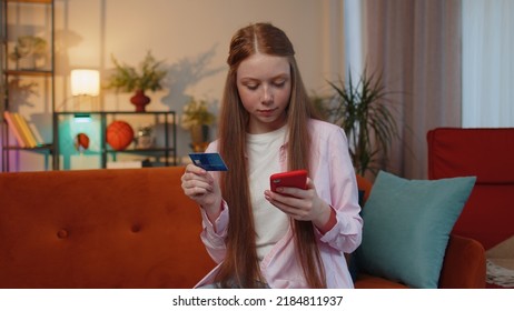 Happy Shopaholic Consumer Young Redhead Teen Child Girl Sitting At Home Making Online Order Food Delivery, Payment With Credit Plastic Bank Card. Discount Sale On Internet. Ginger Female Children Kid