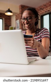 Happy Shopaholic Making Purchase In Internet Store Sale, Holding Credit Card, Online Payment, Electronic Retail Shopping. Smiling Person Buying Products Remotely Using Laptop, Buyer Paying For Order