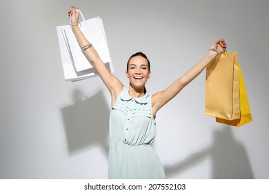 Happy Shoping. Young, Attractive Girl In A Summer Dress With A Large Bag Purchasing 