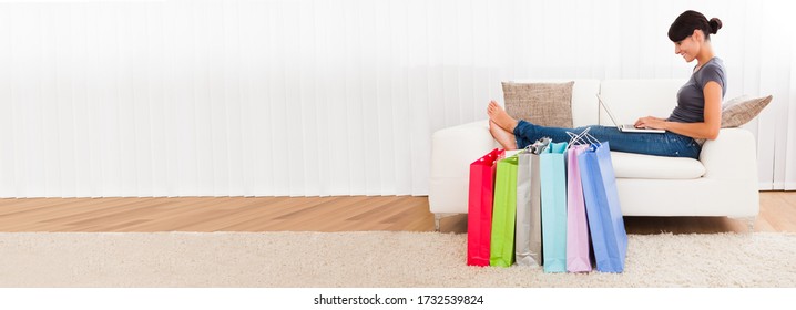 Happy Shopper Woman Shopping Online In Retail Shop