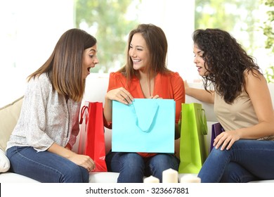 Happy Shoppers With Shopping Bags Talking Sitting On A Couch At Home