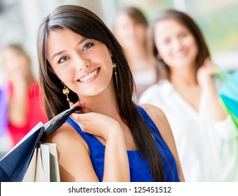 Happy Shopping Woman With A Group Of Friends At The Background