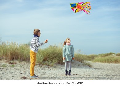 Happy siblings children running and having fun with kite on beach of Baltic sea - Powered by Shutterstock