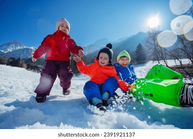 Happy siblings jump and laugh in snow over sunny snowy mountains peaks enjoy winter camp - Powered by Shutterstock